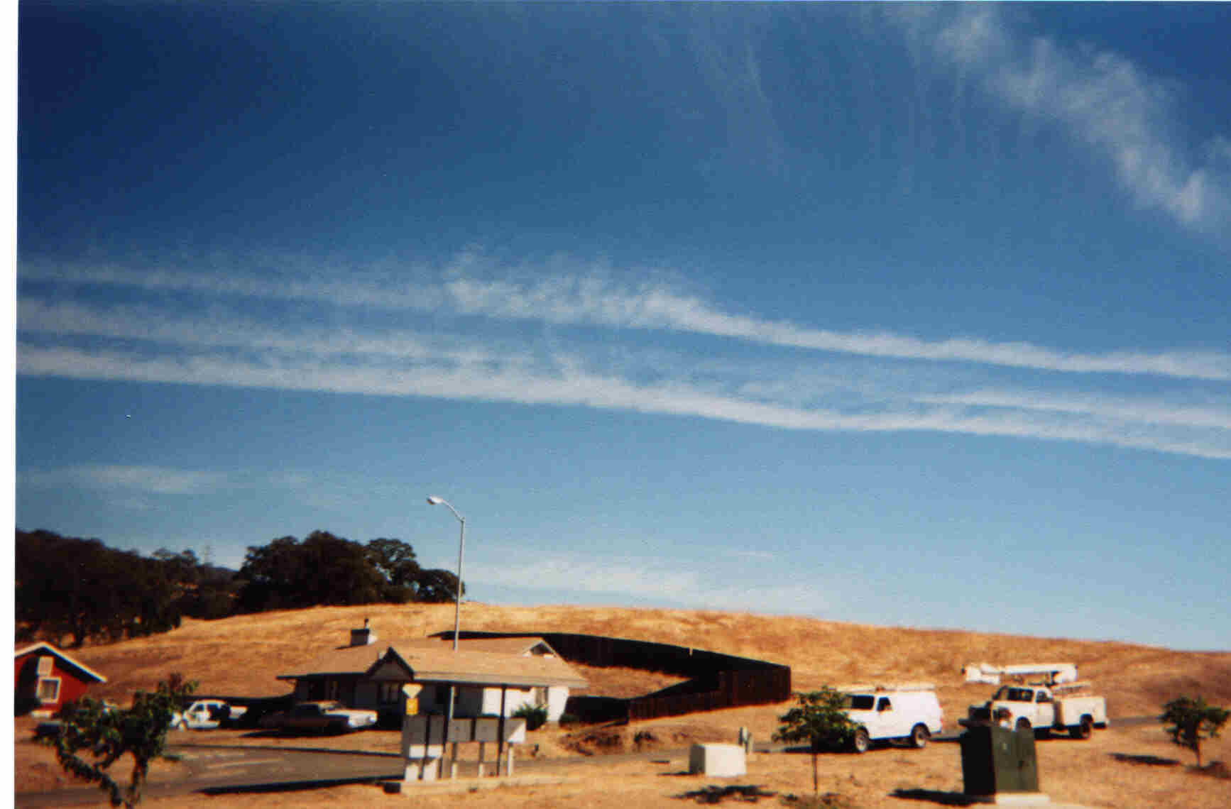 Robinson Rancheria hill where two cable television service trucks are installing cable for the Education Building.